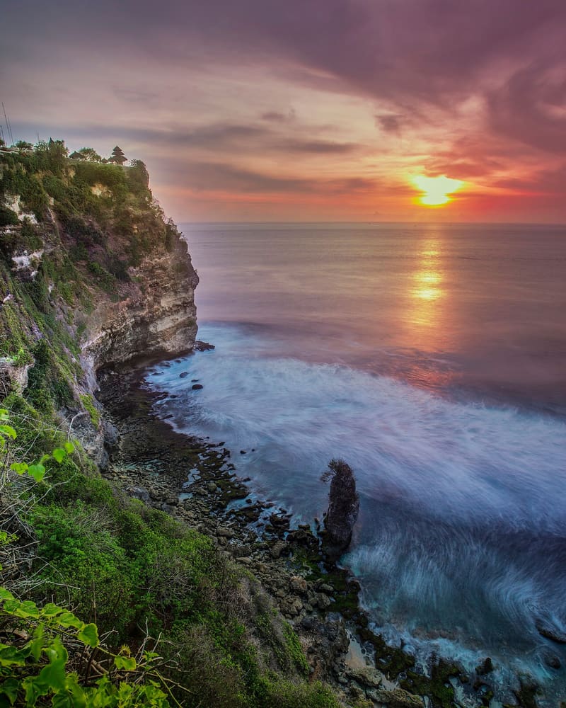 Golden-hour sunset over the cliffs and ocean at Uluwatu, Bali